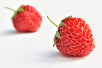Two strawberries isolated on white background