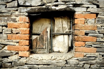 Old devastated window in stonewall