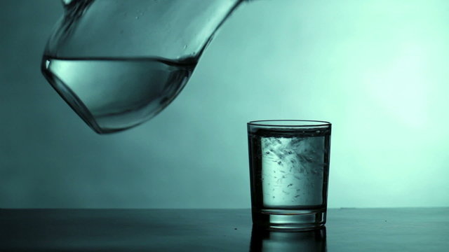 Drinking water is poured into a glass