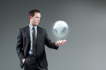 Futuristic technology. Man holding world globe Hologram.