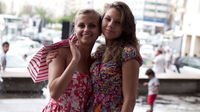 Smiling women after shopping in the city, slow motion shot at 12