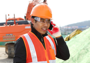 road construction worker communication with mobile phone