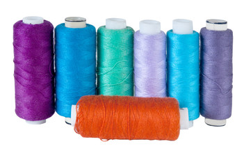 Coils of colour threads on a white background