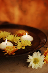 Obraz na płótnie Canvas Aroma Bowl With Candles And Flowers