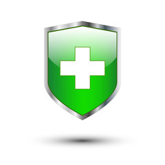 Obraz premium Green cross on shield