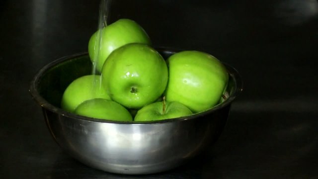 Fresh juicy green apples water slowmotion