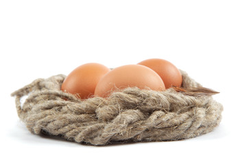 Brown eggs in canvas sack isolated on a white background