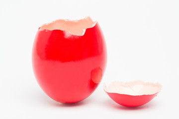 Red painted egg with its top broken off © WavebreakmediaMicro