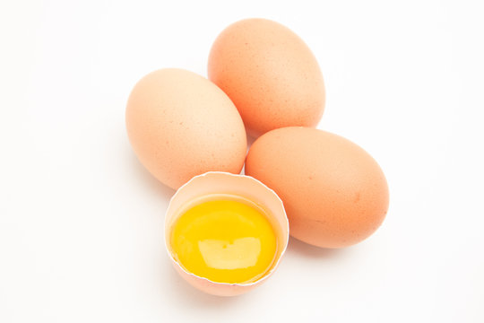 Three eggs with a yolk in half a shell