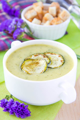 Zucchini cream soup with croutons in white cup
