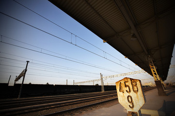 Railway platform with km signpost.