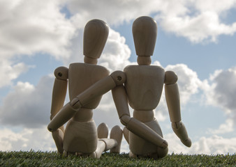 two wooden puppets as loving couple