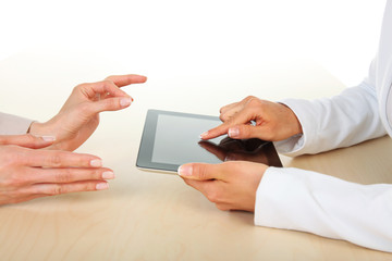 Two businesswomen working with digital tablet