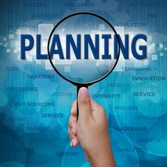 PLANNING in Magnifying glass on blue background