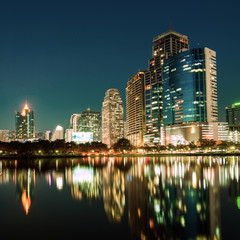 Fototapeta na wymiar City downtown at night with reflection of skyline