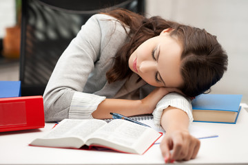bored and tired woman sleeping on the table
