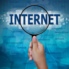 INTERNET in Magnifying glass on blue background