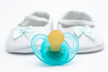 Blue soother with baby booties