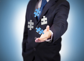 Businessman with digital white and blue puzzles