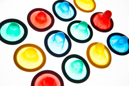 Twelve brightly coloured condoms