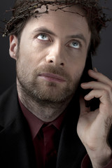 Contemporary man in a crown of thorns - unhappy worker concept