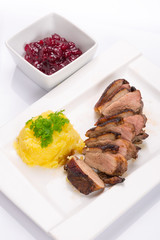 Roasted duck breast with potatoes and cranberry sauce
