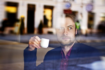 Businessman drinking espresso coffee in the city