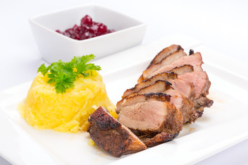 Roasted duck breast with potatoes and cranberry sauce