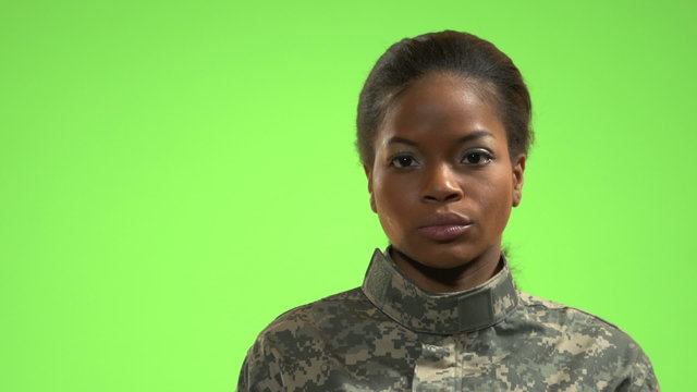 African American female soldier in front of green screen