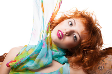 Fototapeta premium Girl with red hair and colorful dress over white
