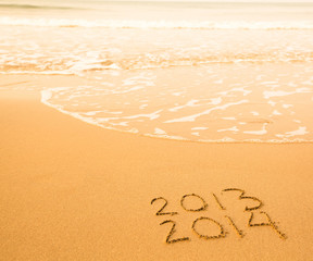 2013 - 2014 written in sand on beach texture