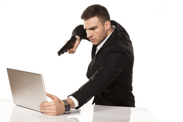 businessman destroying his laptop using guns