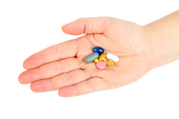 Hand with pills on white background
