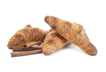 Croissants and stiks cinnamon isolated on white background
