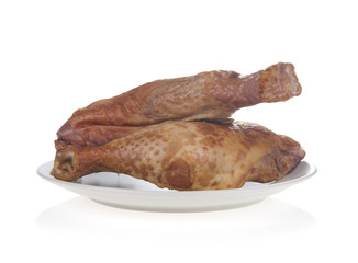 smoked chicken legs in plate, isolated on white