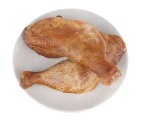 smoked chicken legs in plate, isolated on white