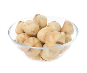 Glass bowl of cookies. Isolated on white background