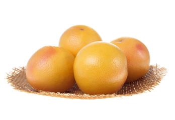 Fresh grapefruits in a basket isolated on white background