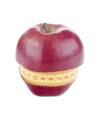 apple and measuring tape on white background