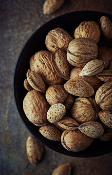 Bowl Of Rustic Walnuts And Almonds