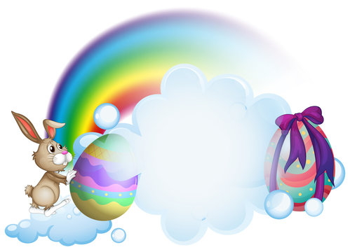 A bunny and the easter eggs near the rainbow