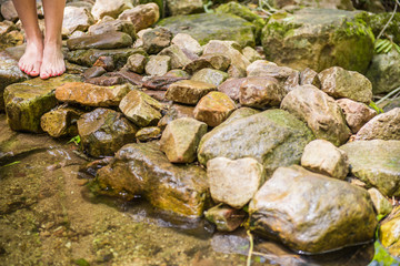Woman walking on stones
