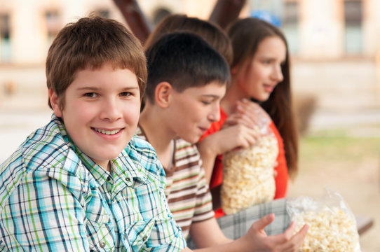 Chubby teenage boy having fun with his friends outdoor