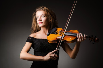 Woman performer with violin in studio