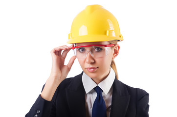 Young businesswoman with hard hat on white