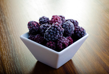 Frozen blackberries in white bowl