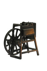 Vintage brass sharpener in form of weaving wheel on white