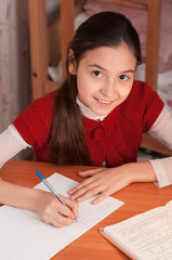 Naklejka na ściany i meble girl doing homework in a notebook
