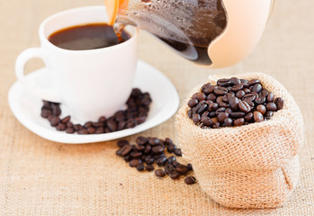 Roasted coffee beans in jute bag
