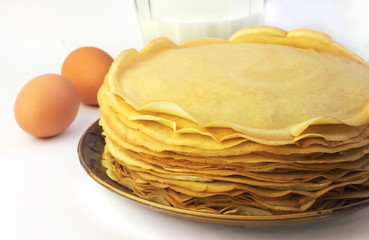 Stack of thin pancakes on a plate